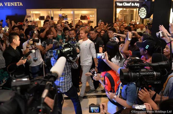 Nico Rosberg (centre, in white), Mercedes Formula 1 driver, at a public appearance event organised by watch brand IWC Schaffhausen at ION Orchard.