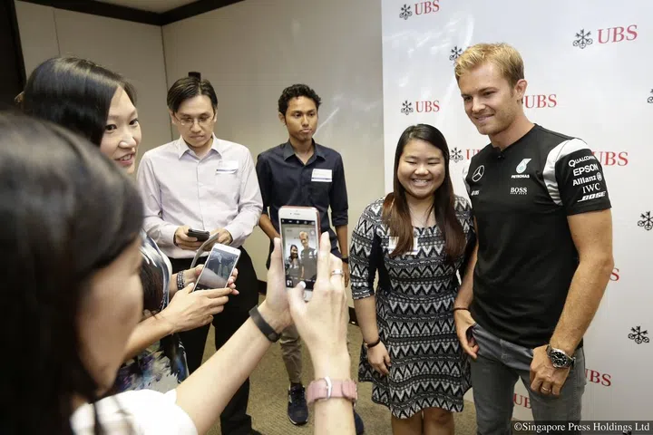 Mercedes Formula One driver Nico Rosberg taking a picture with Ms Simone Wong, a 21-year-old student and one of the winners of the ST-UBS contest at the UBS' office in Raffles Quay on 14 September 2016.