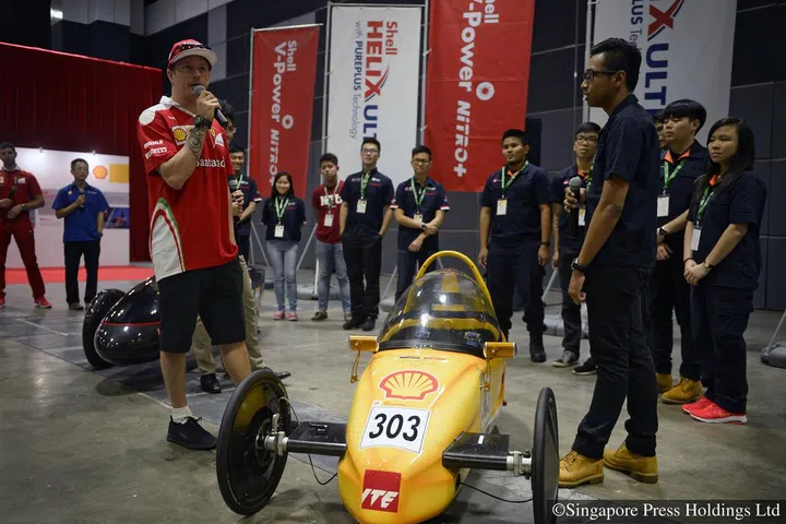 Ferraris Kimi Raikkonen (left) speaks to Singaporean Muhammad Haikal Mohd Azminsham (right) and other participants of the Shell Eco-Marathon Asia at Suntec Convention and Exhibition Centre on 15 September 2016, during a sideline event prior to the Singapore Airlines Singapore Grand Prix.