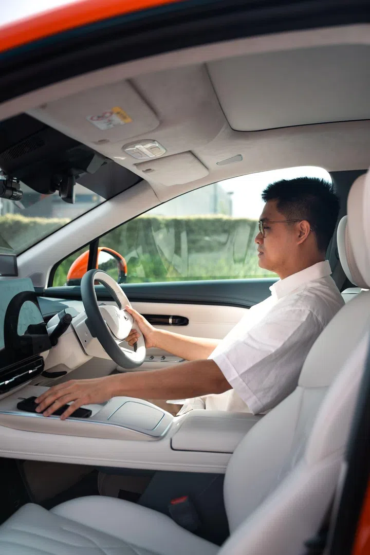 Ernest Tan seated in the driver’s seat of the GAC Hyptec HT, highlighting the vehicle’s modern interior and driving environment.