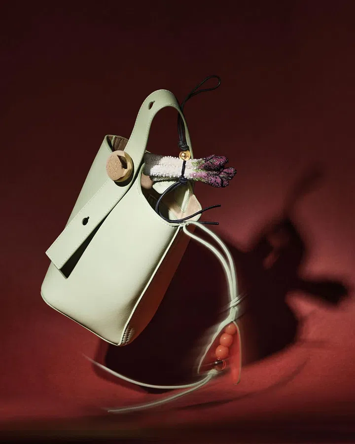 Loewe Pebble Bucket手袋搭配珠饰毛毡芦笋挂饰和经典牛皮革豌豆荚挂饰。
