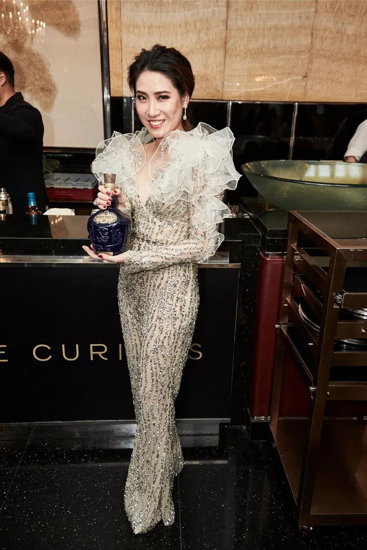 Angelina Tan holding Royal Salute