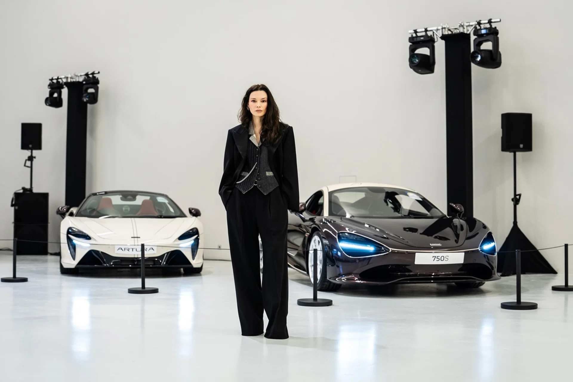 Chelsea Scott-Blackhall stands in front of the McLaren 750S Coupe and Artura Spider, created for the Project Duality collaboration between DZOJCHEN and McLaren Singapore.