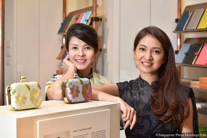 Fashion designer Priscilla Shunmugam of Ong Shunmugam and stationary company Bynd Artisan's founder Winnie Chan (left) with their collaboration collection of clutches. 