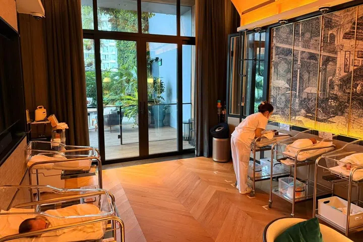 Nurses caring for newborn babies in DeRAMA Singapore’s dedicated nursery within the hotel Artyzen Singapore