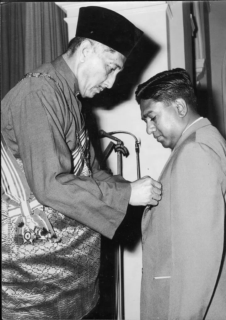 National Day 1964 - Singapore National Day Honours. Mr S. R.Nathan, Director of the Labour Research Unit, receiving the Bintang Bakti Masharakat (Public Service Star) from the Yang di-Pertuan Negara, Tun Yusof bin Ishak.