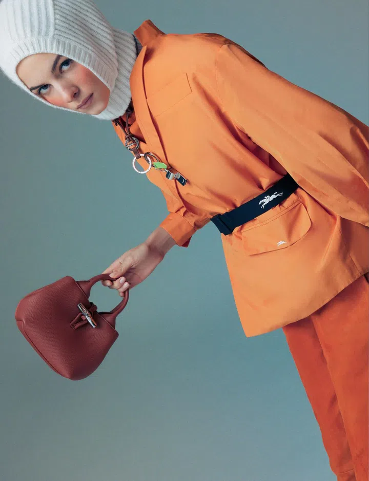 Longchamp top $1,860, jacket $890, trousers $2,510, balaclava $360, belt $205, key ring (worn as necklace) $160, whistle key ring $160, Le Roseau bag $965