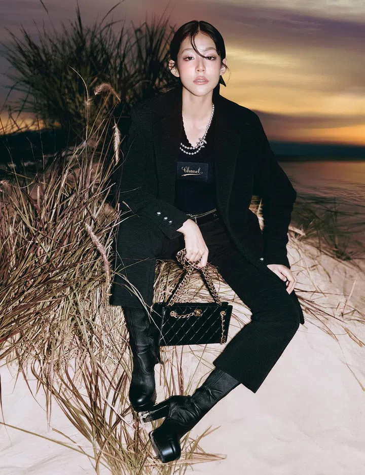Chanel top $3,370, peacoat $11,650, trousers $5,060, belt $2,400, necklace $2,160, bag $8,120, boots $3,530