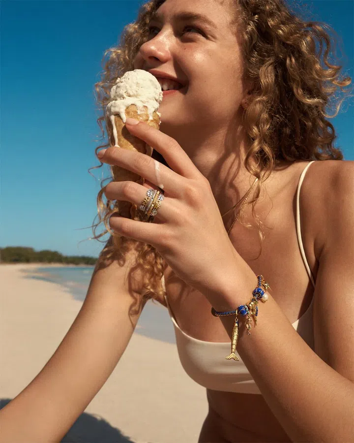 Model wearing Pandora Moments charm bracelet and matching ring inspired by ocean-themed summer styling.