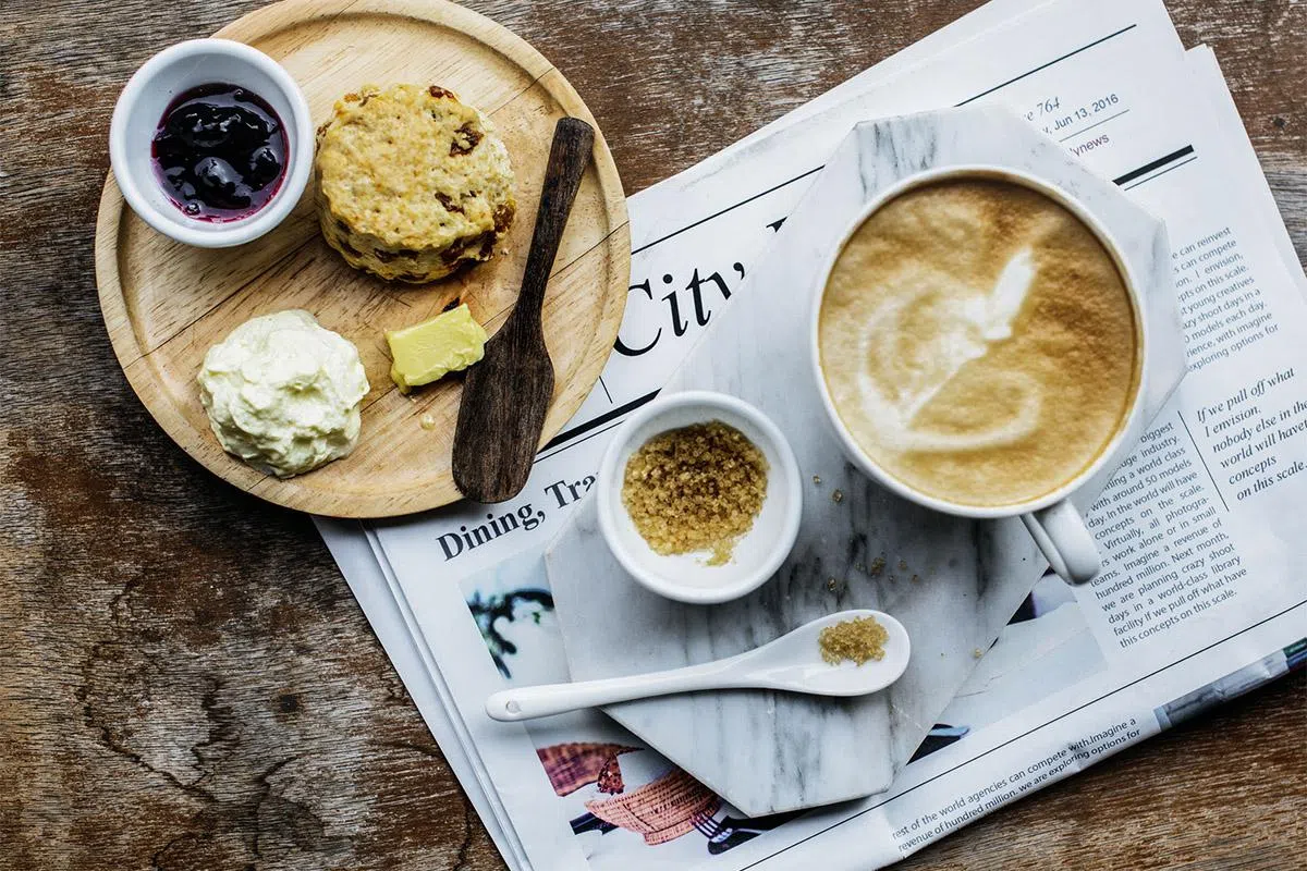 65650910 - coffee shop cafe latte cappuccino newspaper concept