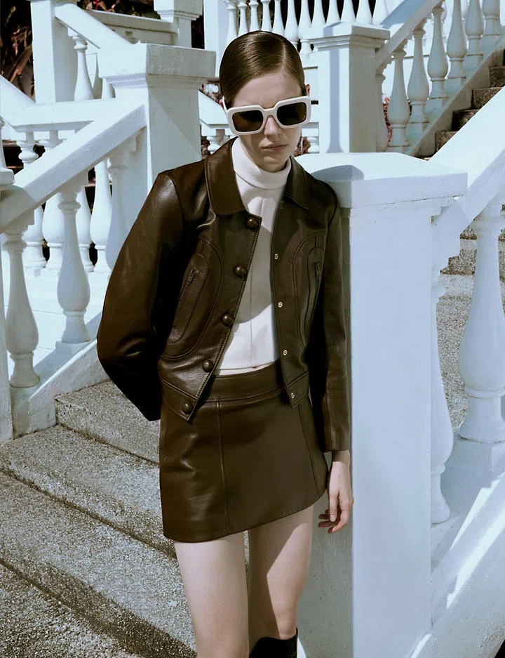 CELINE BY HEDI SLIMANE top $2,500, jacket $7,600, skirt $4,100, sunglasses $820, boots $2,950