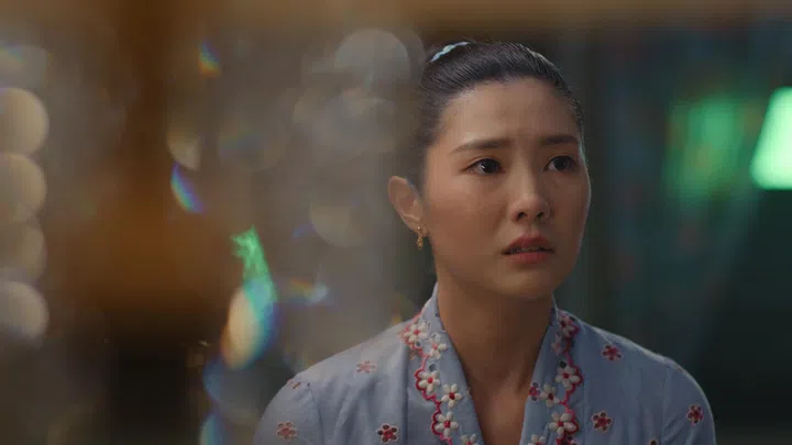 Ferlyn G在《小娘惹之翡翠山》中饰演张安雅，穿着浅蓝色娘惹风上衣、神情隐忍地望向前方，画面带有柔焦光影效果。