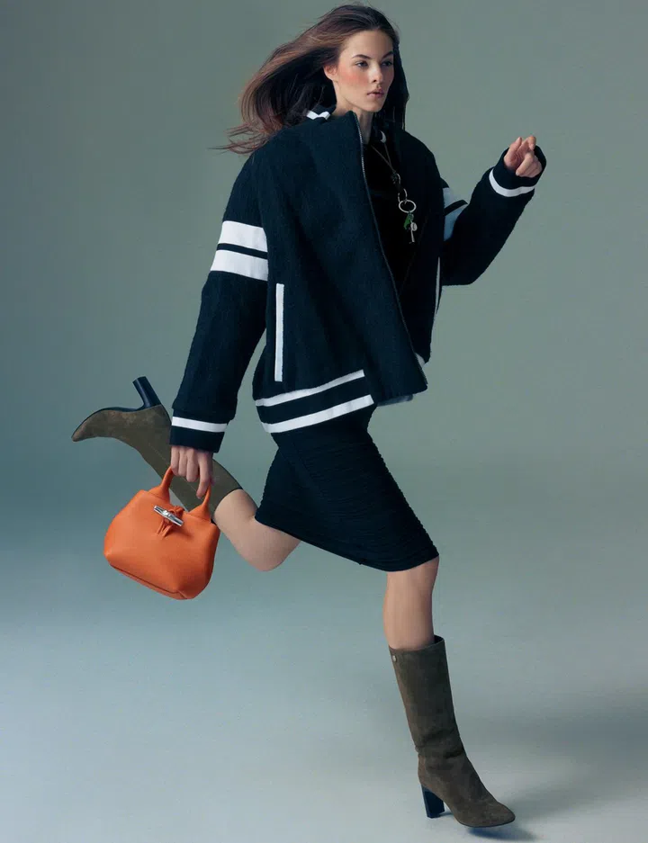 Longchamp dress $835, blouson $1,490, key ring (worn as necklace) $160, whistle key ring $160, Le Roseau bag $965, boots $1,290