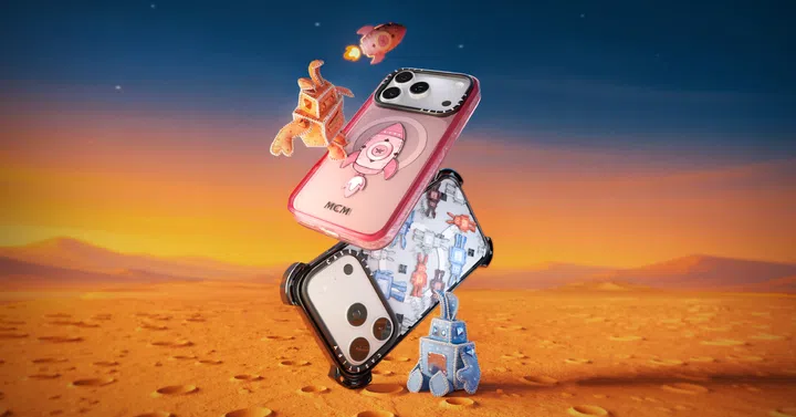 CASETiFY 与 MCM 联名手机壳视觉图，画面呈现多款手机壳堆叠于沙漠般的未来场景中，设计包含 MCM 标志性的 Visetos 图案，以及 Rabot 机器人兔与火箭元素，色调以粉色、黑色与蓝色为主，展现融合奢华品牌美学与科技防护机能的限量联名手机壳系列，适合关注奢侈品牌联名与设计感手机配件的读者。