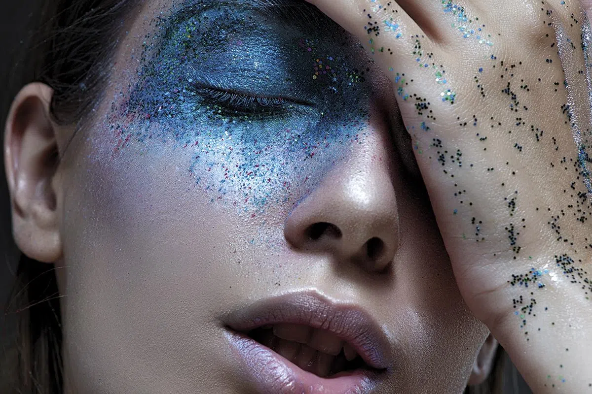 vivid portrait of a girl with an unusual blue make-up.