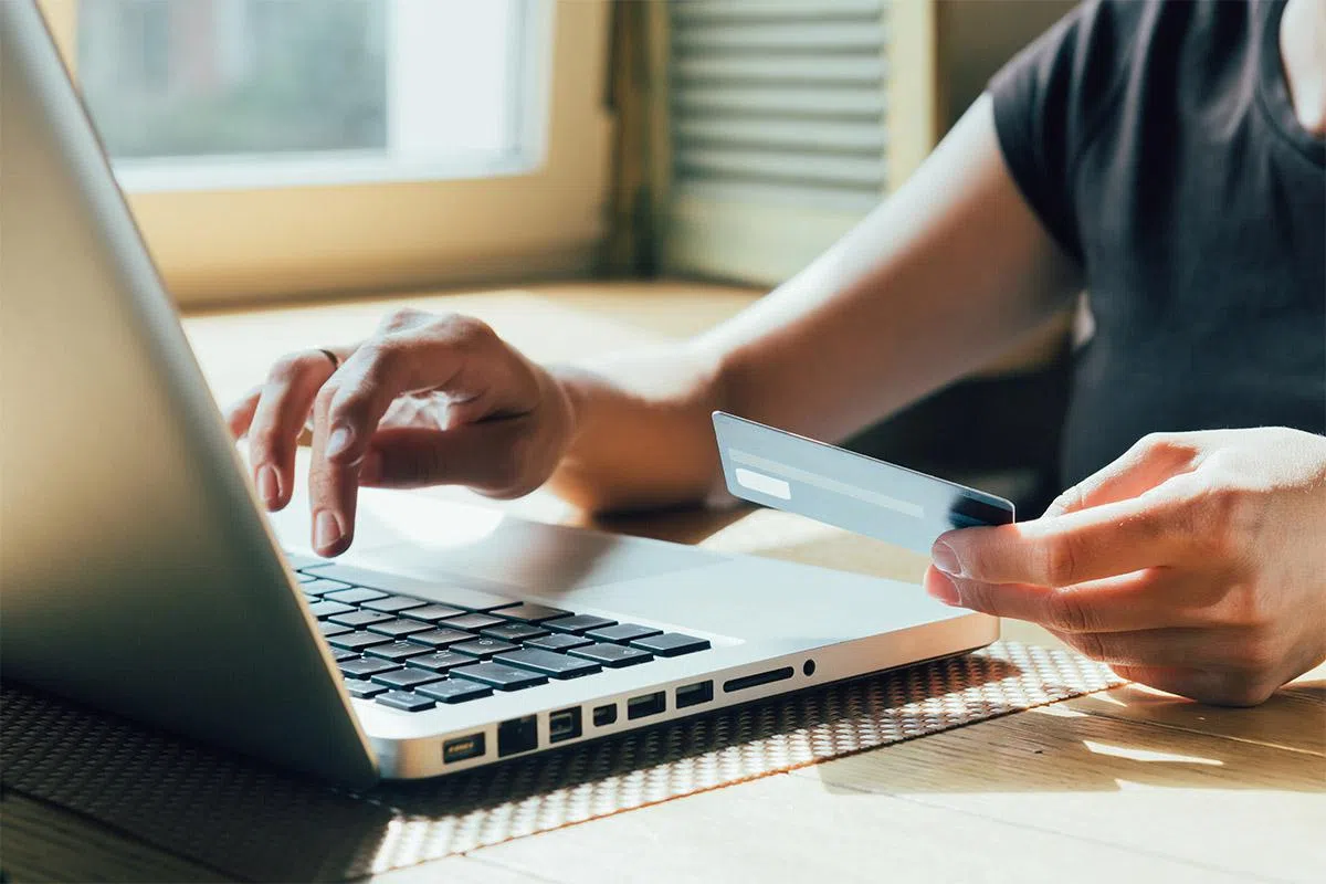 girl makes a purchase on the Internet on the computer with credit card