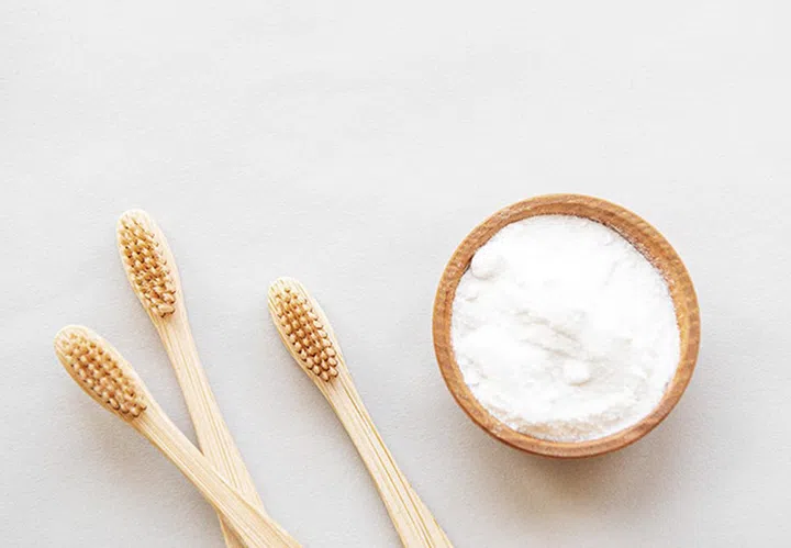 Wooden bamboo eco friendly toothbrushes, baking soda  on white background. Dental care and zero waste concept