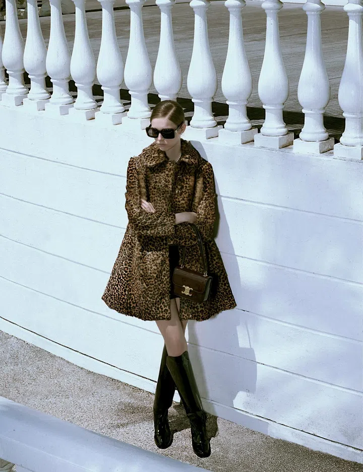 CELINE BY HEDI SLIMANE dress $4,450, coat (POA), Teen Garance bag $5,600, sunglasses $820, earrings $690, necklace $1,550, boots $2,950