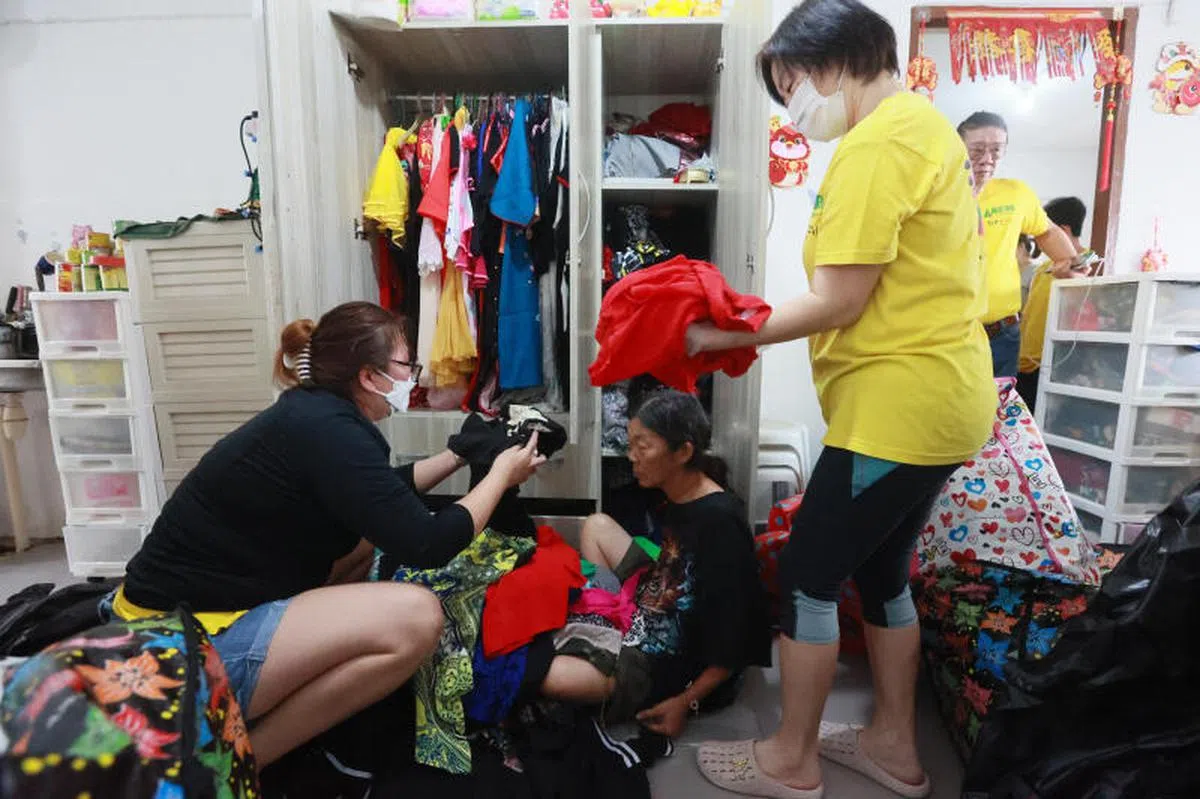 65与60岁的郑氏姐妹住在后港3道一个租赁组屋单位，单位堆满杂物容不下身，六旬姐妹睡组屋楼下3个月，甚至还因“垃圾屋”着火被迫搬家。但单位内的囤积物日益增多，影响生活。义工帮忙清理多余的衣服，有超过100件。（新明日报）