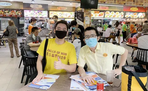 杨耀辉（右）在咖啡店里接见选民。（新明日报）