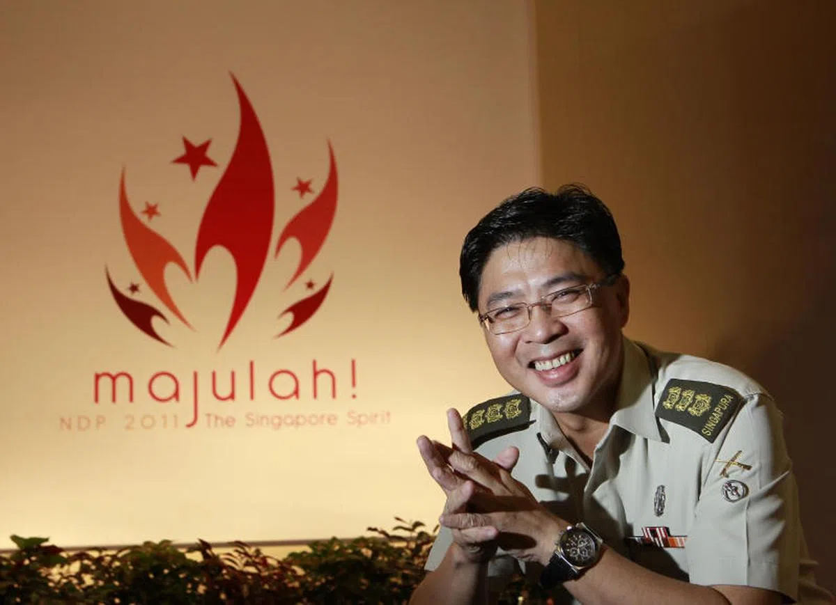  2011年，44岁的揭育文担任国庆庆典执行委员会主席，面对镜头笑得灿烂。（联合早报） 