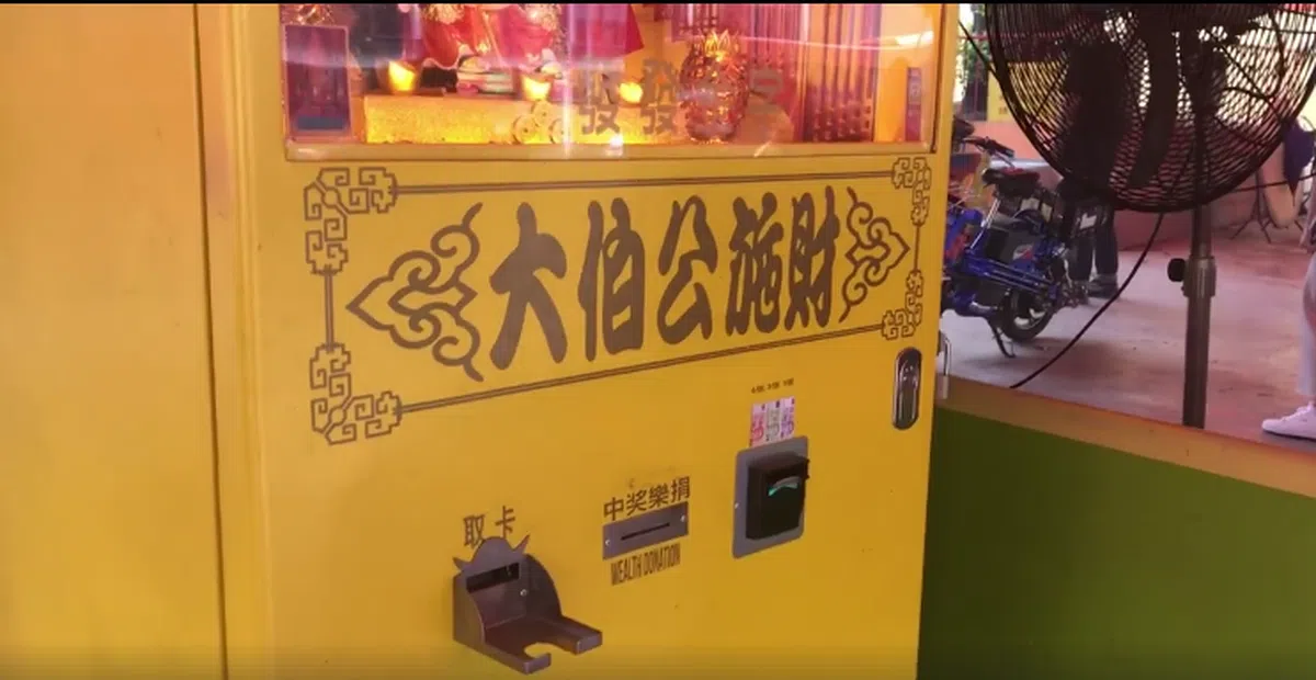  机器写着“大伯公施财”。（联合早报） 