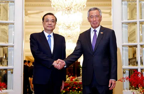 我国总理李显龙（右）在总统府会见到访的中国国务院总理李克强。（路透社）