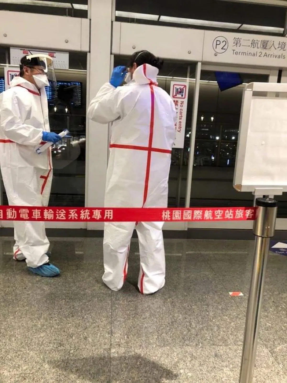 机场内，几乎所有工作人员都穿上白色防护衣。（卢丽珊摄）