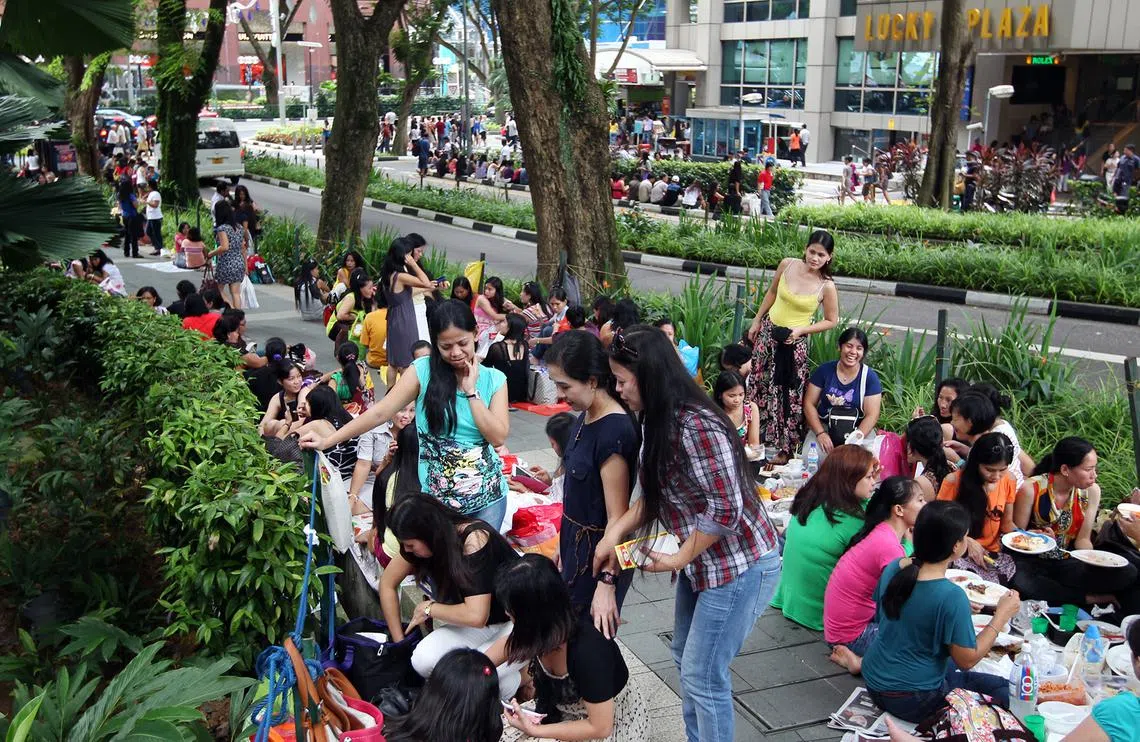 聚集在幸运商业中心附近的菲律宾移工。（海峡时报档案照）