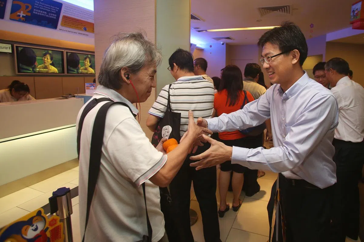 2013年2月13日是农历新年假期结束后的第一个工作日，不少银行一大早就出现了存取款项的人龙。储蓄银行董事总经理兼主管吴顺喜（右）和部分星展银行的高级管理人员，到储蓄银行位于白沙的分行迎接客户的到来并送上诚挚祝福。（联合早报）