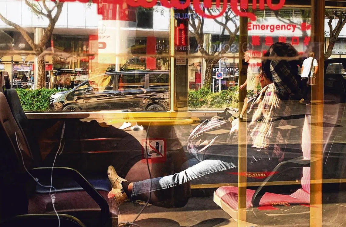 新加坡公共巴士上的不文明行为：将脚搁在对面座位上。（海峡时报）