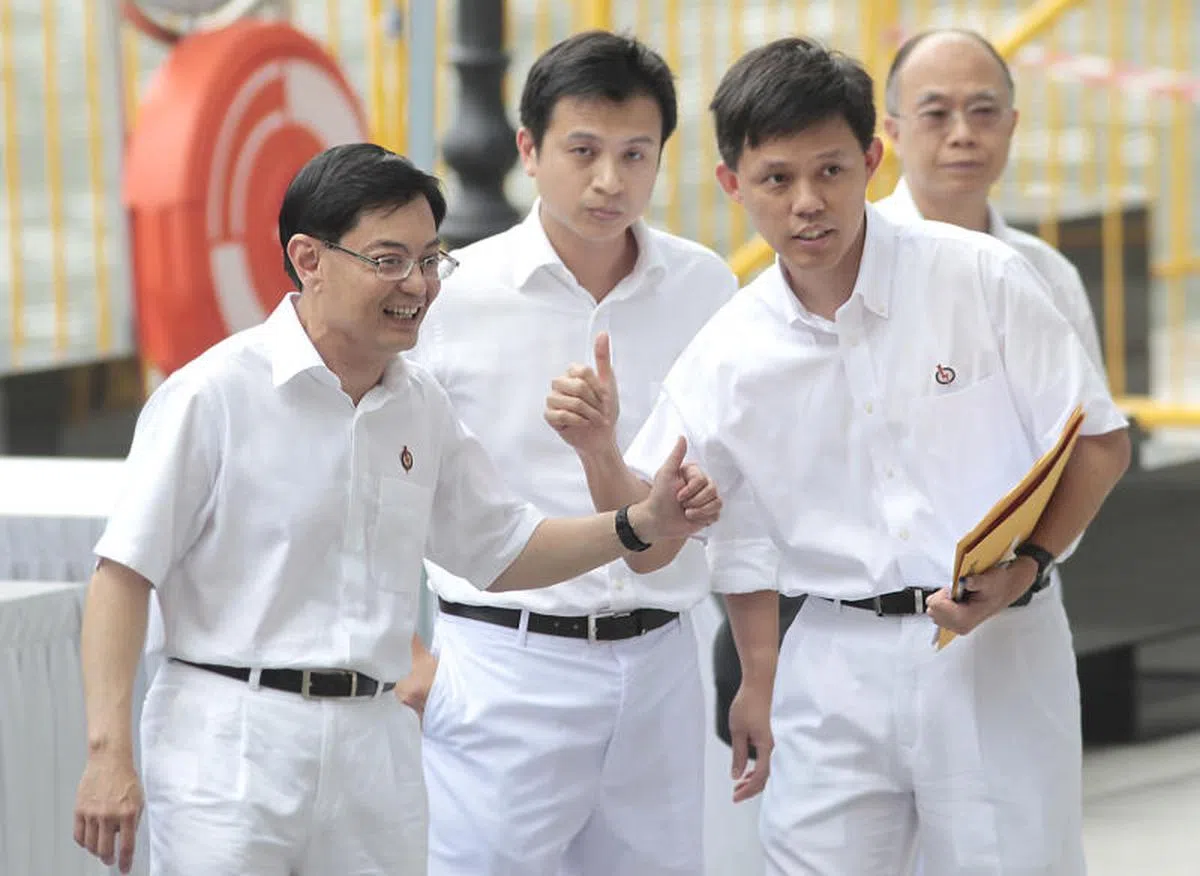  左起：王瑞杰、谢世儒和陈振声身穿人民行动党制服摄于2011年。（商业时报） 