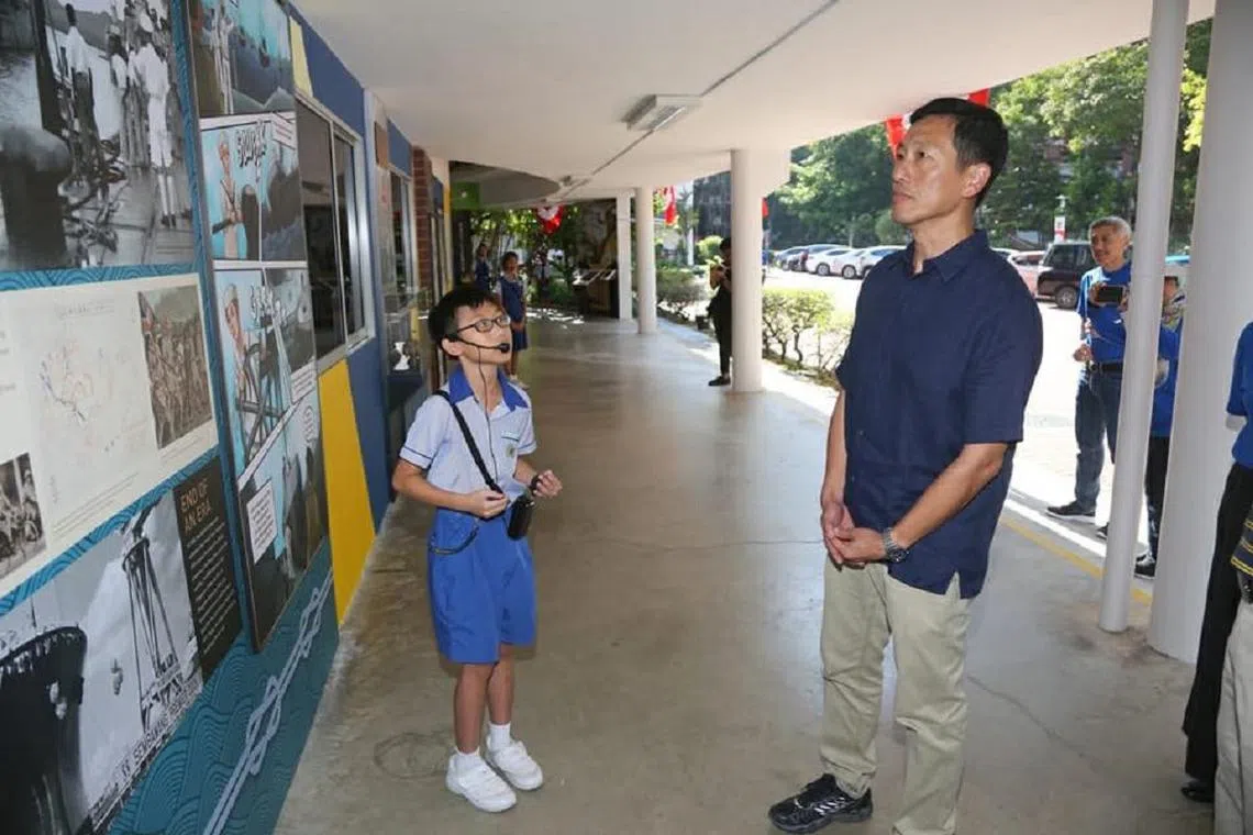 教育部长王乙康参观胜宝旺小学历史文化角落时，聆听小小导览员的介绍。（王乙康面簿）