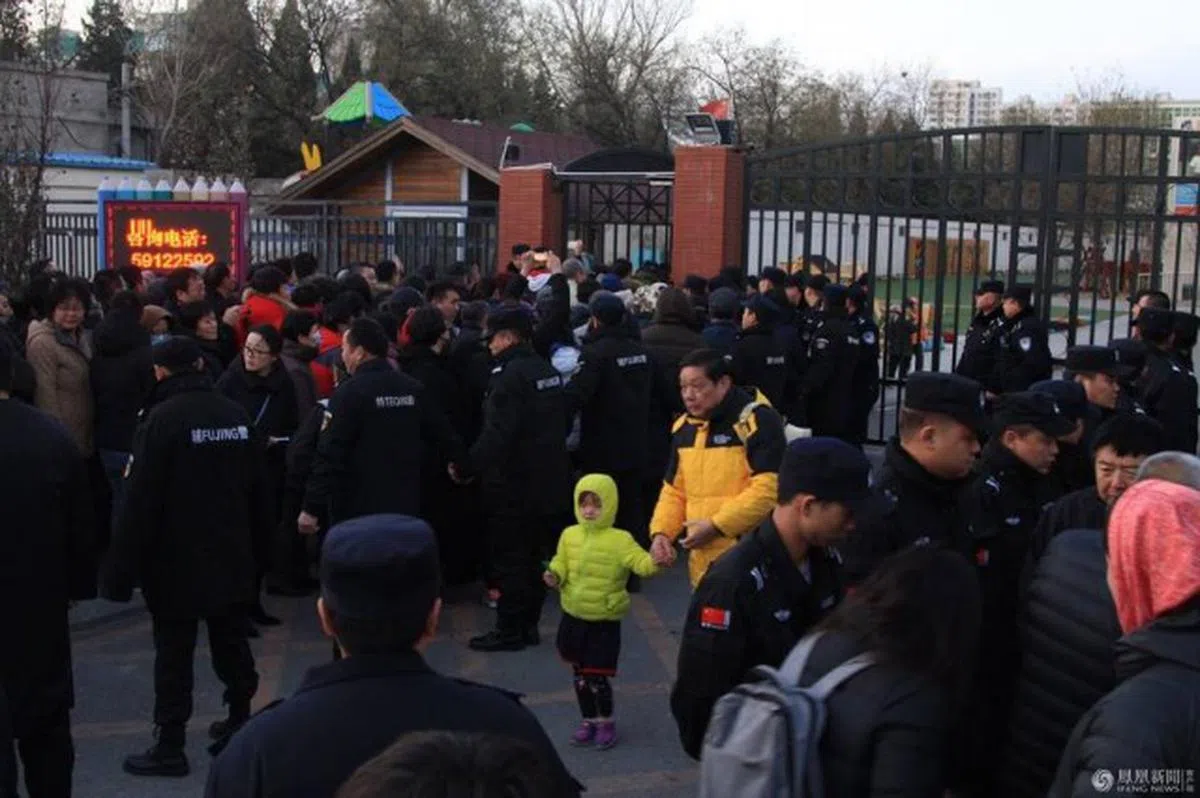  北京新天地红黄蓝幼儿园涉嫌虐待儿童，家长到幼儿园门口找学校要说法。（凤凰网） 