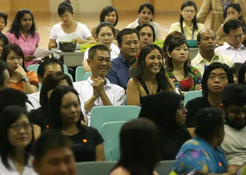 一对父母得知孩子被心仪的小学录取后，笑逐颜开。（联合早报档案照）