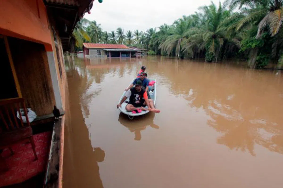  马国水灾导致成千上万的灾民被迫撤离家园，截至上周五（8日）已有六个州属、超过4万8000灾黎逃离至全国400间疏散中心。图为彭亨关丹甘榜士曼加特，灾民仍须靠小船出入居所。（星洲日报） 
