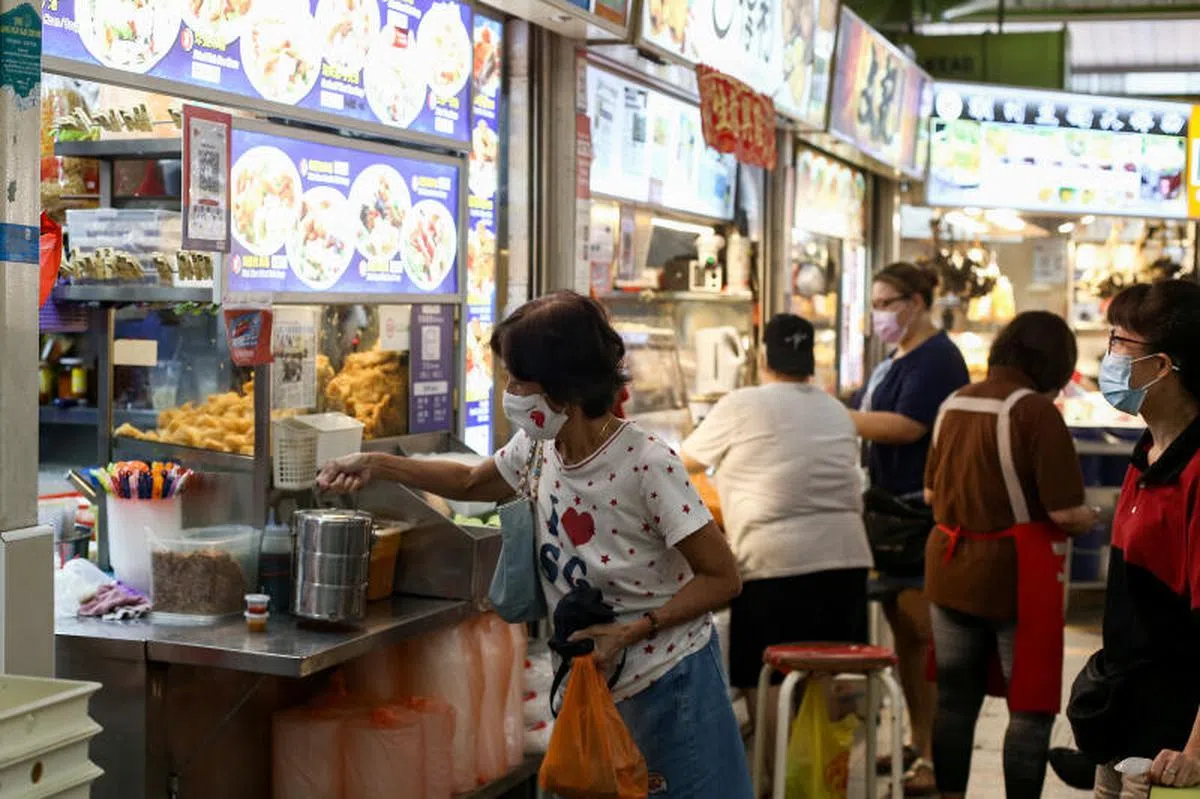  自带餐盒打包食物的民众。（联合早报） 