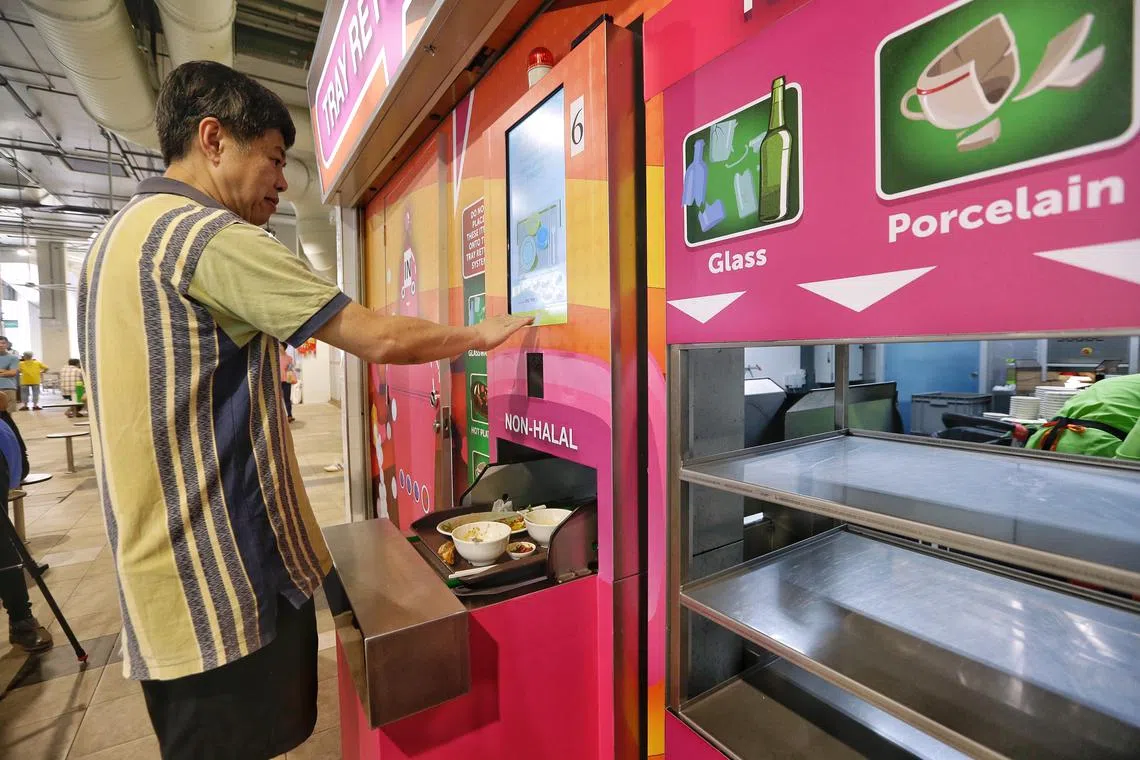 马西岭商场小贩中心增设了自动化归还托盘系统，食客归还托盘后，可拿回五角钱押金。（海峡时报）