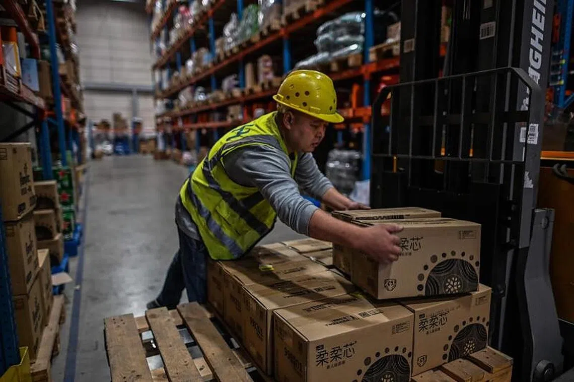 在线支付平台PayPal的一项调查显示，新加坡人在中国电商平台的交易量与日俱增。图为一名江苏省无锡市菜鸟物流公司的仓库职员。（法新社）