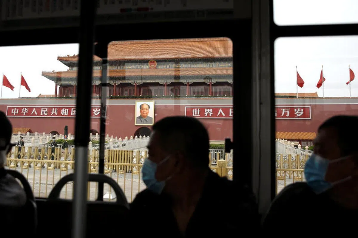  搭乘公交车途经北京天安门的乘客都戴着口罩。（路透社） 