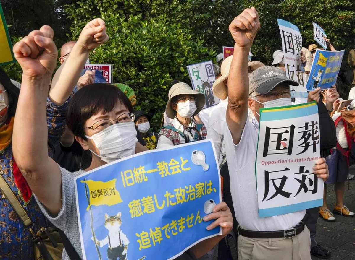 日本民众手持标语，抗议国葬。（欧新社）