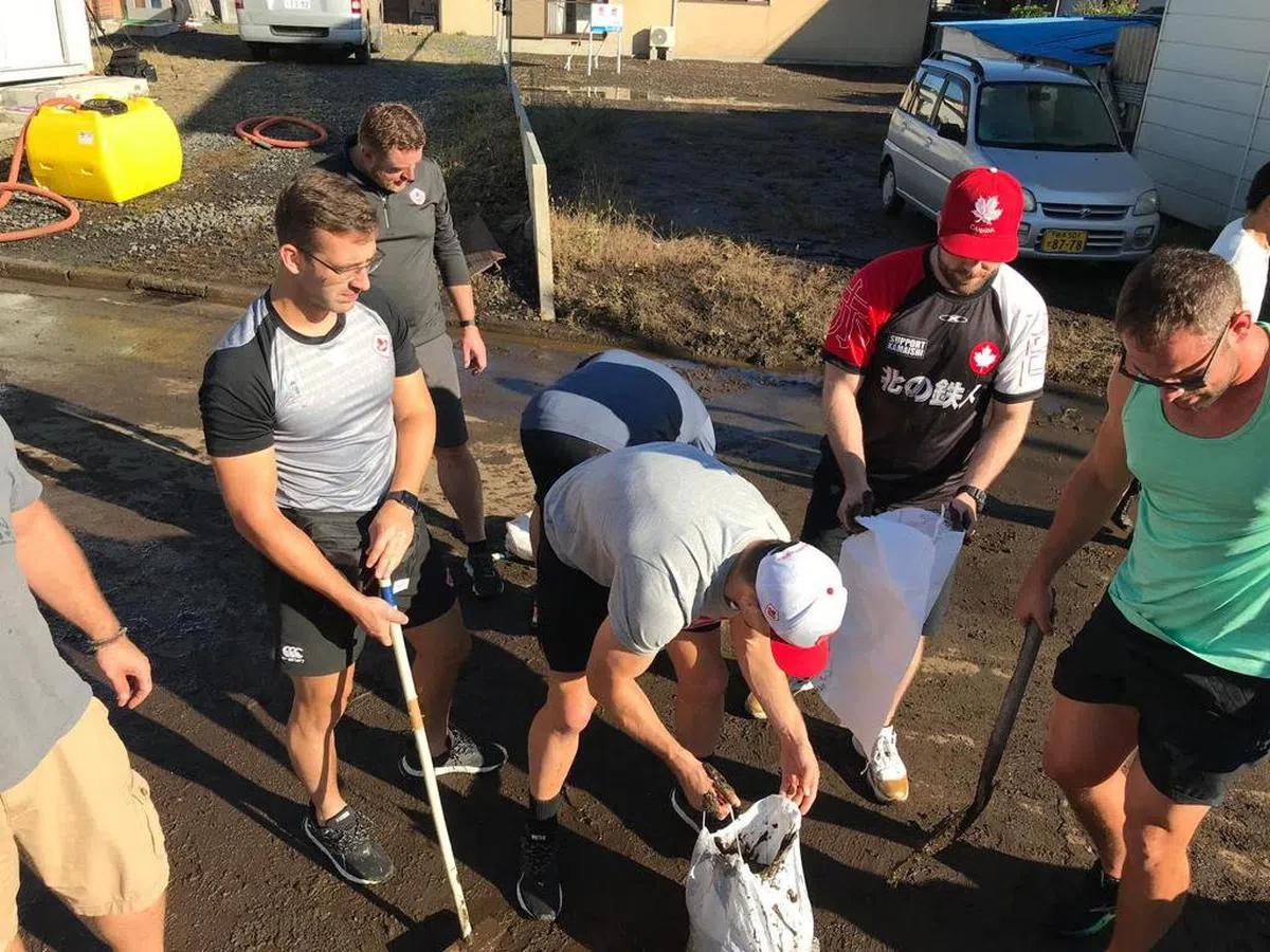  球员们用铲子清走在路中央的烂泥。（rugbyworldcupjp推特账号） 