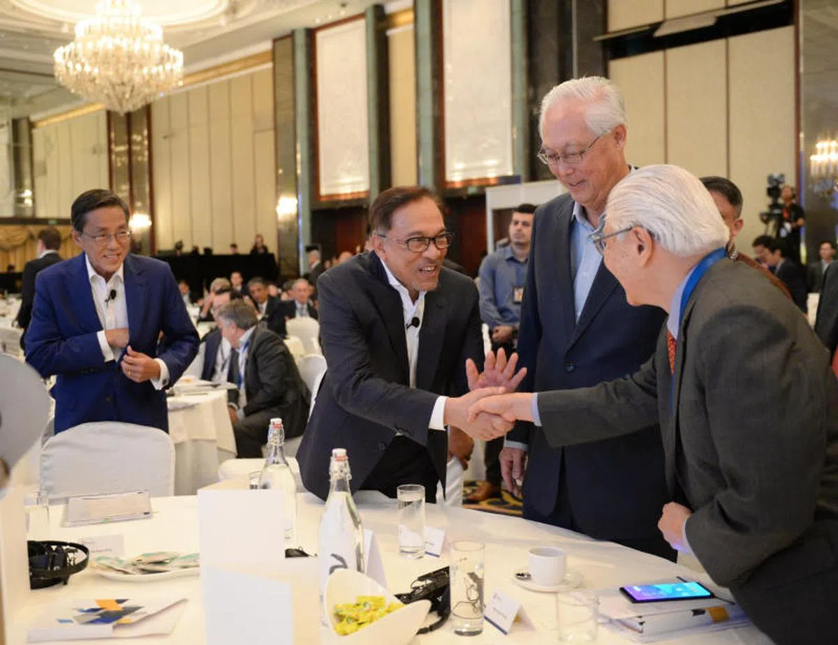  马来西亚人民公正党实权领袖安华（右三）15日在新加坡峰会上和新加坡前总统陈庆炎（右一）握手寒暄。右二为荣誉国务资政吴作栋；左一为悦榕控股执行主席何光平。（联合早报） 