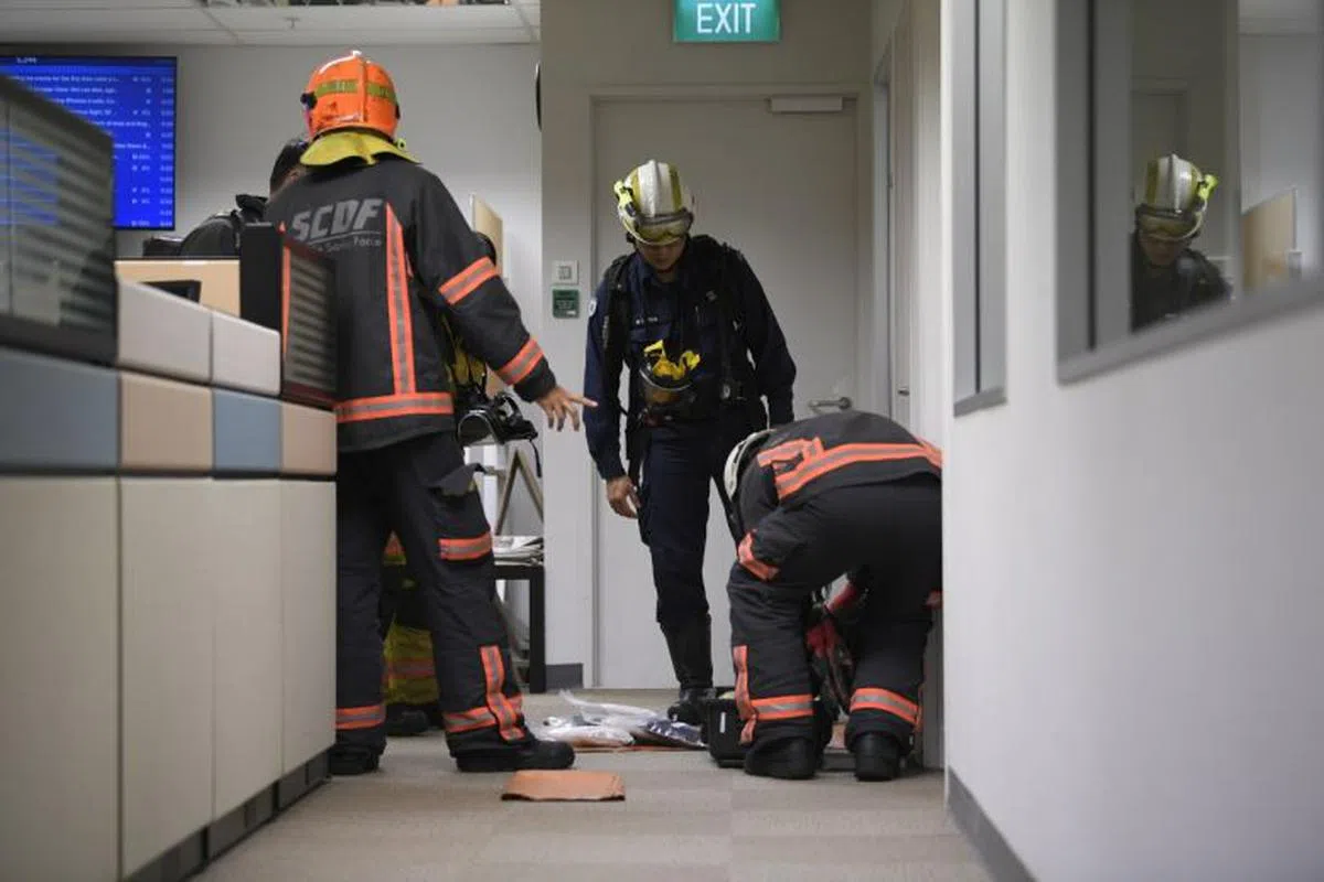 警察和民防部队人员今天到位于大巴窑北部报业中心的海峡时报新闻室，调查神秘信件事件。（海峡时报） 
