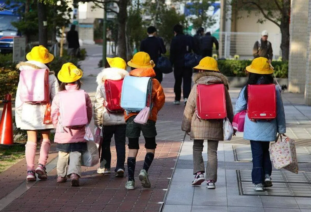 日本小学生一起走路上学，连帽子和书包都一模一样。（互联网）