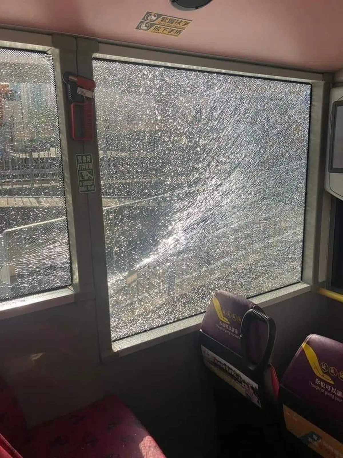  公共巴士在行驶时玻璃窗口遭砸毁，出现无数条裂痕。（我爱旅行面簿） 