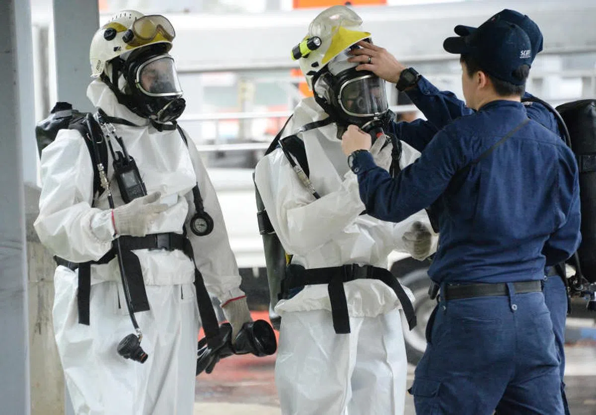  民防人员穿上太空装大阵仗进入兀里站内调查“白粉”事件。（新明日报） 