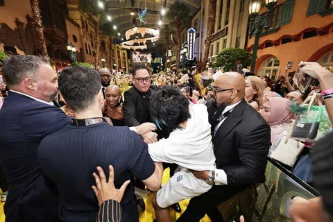 冲向亚莉安娜的文·约翰逊（白衣）被保安们拉走。