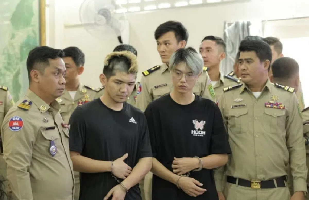 身穿黑衣的两名台湾网红，因在柬埔寨拍摄造假视频，被判两年监禁。（柬中时报）
