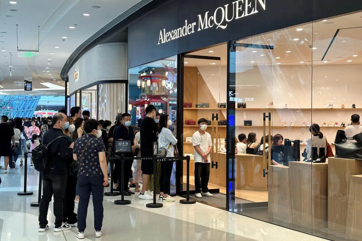 中国消费者在海南三亚国际免税城的英国奢侈品店亚历山大·麦昆（Alexander McQueen）外排队等待进入。（路透社）
